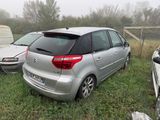 a silver car that is parked in the grass