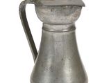 an old silver pitcher with a handle on a white background