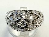 a close up of a ring with diamonds on a white surface
