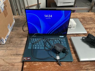 a laptop computer sitting on top of a wooden table