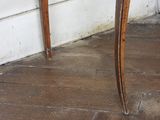 a wooden table with a marble top on a hard wood floor