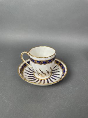 a cup and saucer with a blue and white design
