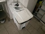 an image of a kitchen with a sink and a trash can