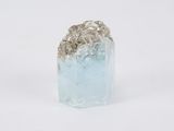 a small piece of ice sitting on top of a white surface
