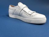 the white shoe is on a blue surface with a blue background