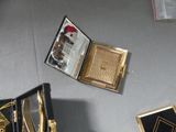a small box with a clock inside of it on a table
