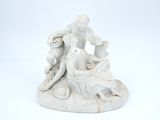 a statue of a man and a woman sitting on a rock