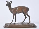 bronze statue of a deer on a wooden base on a white background