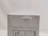 a close up of a white box on a table with a string