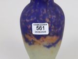 a purple vase with a tag on it sitting on a table
