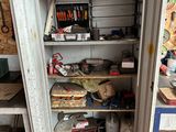 an open cabinet with tools on it in a garage