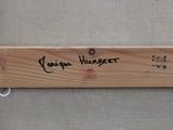 a piece of wood that has writing on it