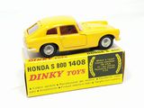 yellow toy car in a box on a white surface