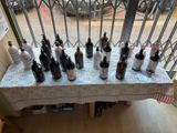 many bottles of wine on a table in front of a window