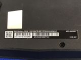 the back of a black laptop with a barcode on it