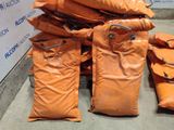 bags of sand sitting on the ground next to a wall