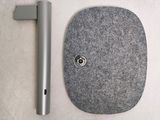 a gray object sitting on a table next to a metal object