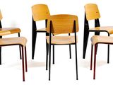 several chairs are lined up in a row on a white surface