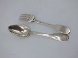 two spoons and a fork sitting on a table