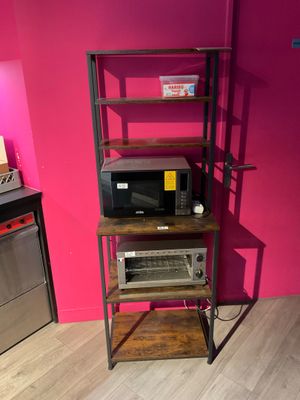 a microwave and a microwave oven on a shelf in a room