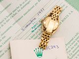 a rolex watch sitting on top of a piece of paper