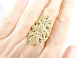 an image of a woman ' s hand holding a gold and diamond ring