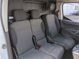four seats in the back of a van that are empty