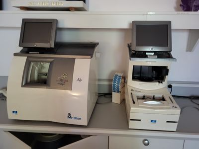 two computers and a printer sitting on a desk