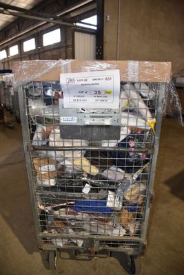 a metal cart with many items in it in a warehouse