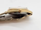 a close up of a watch on a white surface