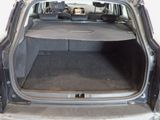 the back of a car with its trunk open and the back seats folded down