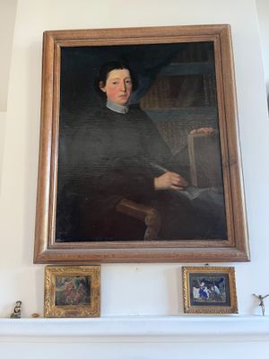 a painting of a man sitting on a mantle in a living room