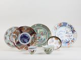 many different types of plates and bowls on the table