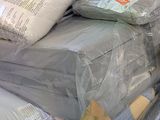 a pile of mattresses and pillows in a store