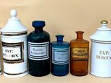 many different types of jars and containers on the table