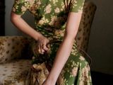 a woman that is sitting on a couch with a purse