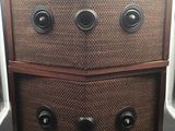two brown wicker drawers with black knobs on top of them