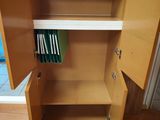 a wooden cabinet with a door open and a file folder in it