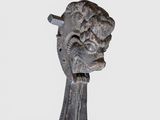 a close up of a sculpture of a head on a stand