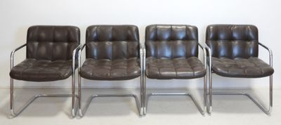 three brown leather chairs sitting next to each other on a white floor
