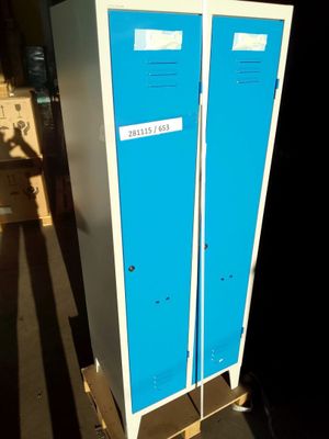two blue lockers sitting on a pallet in a warehouse