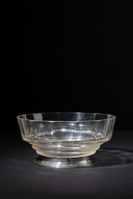 a clear glass bowl sitting on top of a black table