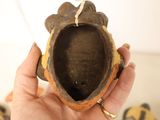 a person holding a small brown object in their hand