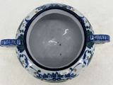 a blue and white vase with a bird on it