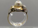 a ring with a pearl and a diamond on it