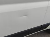 a white van with a black stripe on the side of it