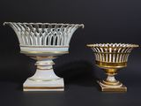 pair of white and gold vases on a black background