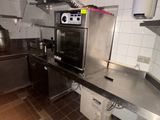 a kitchen with a stove, oven, and sink in it