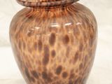 a vase that is sitting on a white surface