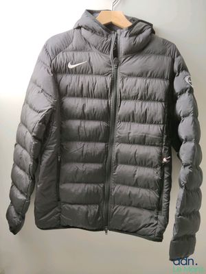 the jacket is hanging on a hanger on the wall